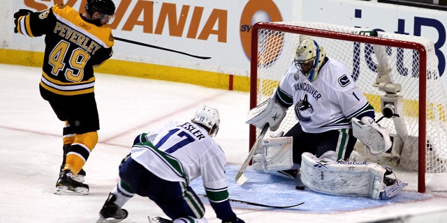 Mark Recchi of the Bruins scores against Roberto Luongo of the Vancouver Canucks during the 2011 NHL Stanley Cup Final at TD Garden on June 6, 2011, in Boston, Massachusetts.