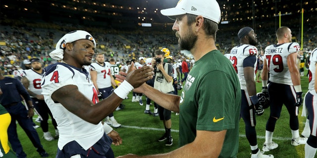 Deshaun Watson #4 of the Houston Texans and Aaron Rodgers #12 of the Green Bay Packers meet after the Packers beat the Texans 28-26 in a preseason game at Lambeau Field on August 08, 2019, in Green Bay, Wisconsin.