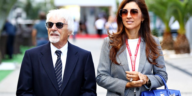 Bernie Ecclestone, Chairman Emeritus of the Formula One Group, and his wife Fabiana walk in the Paddock before the F1 Grand Prix of Russia at Sochi Autodrom on September 29, 2019, in Sochi, Rusia.