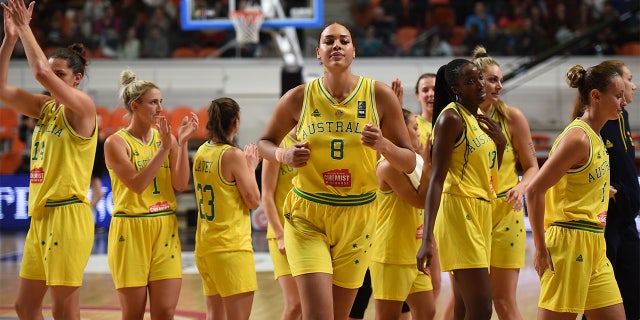 Australia's Liz Cambage (8) and her teammates react after winning a game against Puerto Rico during the FIBA Women's Olympic qualifying tournament Feb. 8, 2020, at the Prado stadium in Bourges, Center France.