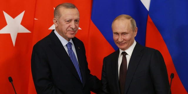 Russian President Vladimir Putin and Turkish President Recep Tayyip Erdogan shake hands during their talks at the Kremlin on March 5, 2020, in Moscow, Russia. 