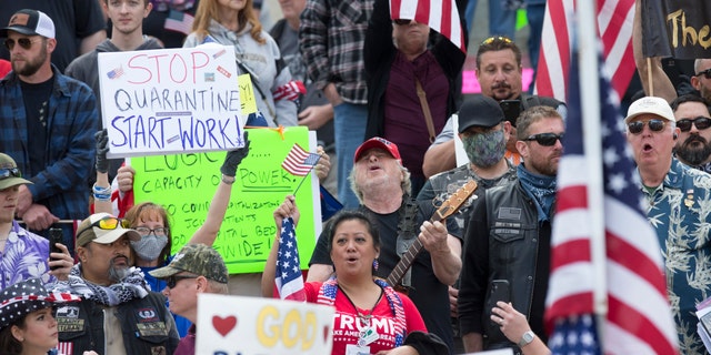 OLYMPIA, WA - APRIL 19: Hundreds gather to protest the state's stay-at-home order, at the Capitol building on April 19, 2020 in Olympia, Washington. Washington state Gov. Jay Inslee instituted the order last month in an effort to slow the spread of the coronavirus (COVID-19).