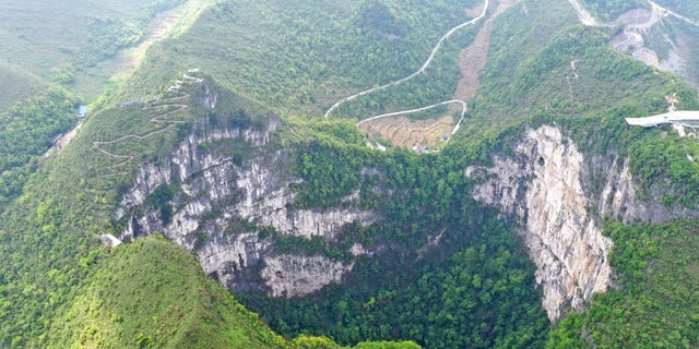 FILE - Aerial Photo taken on April 19, 2020, shows the scenery of Dashiwei Tiankeng, a giant karst sinkhole, at Leye-Fengshan Global Geopark in south China's Guangxi Zhuang Autonomous Region. The Leye-Fengshan Geopark was added to the UNESCO's Global Geopark List in 2010. 