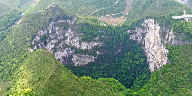 FILE - Aerial Photo taken on April 19, 2020, shows the scenery of Dashiwei Tiankeng, a giant karst sinkhole, at Leye-Fengshan Global Geopark in south China's Guangxi Zhuang Autonomous Region. The Leye-Fengshan Geopark was added to the UNESCO's Global Geopark List in 2010.