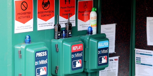 A detail shot of the Mitel Press, Replay and Bullpen phones and the social distancing signs in the dugout prior to the game between the New York Yankees and the Washington Nationals at Nationals Park on Thursday, July 23, 2020, in Washington, District of Columbia.