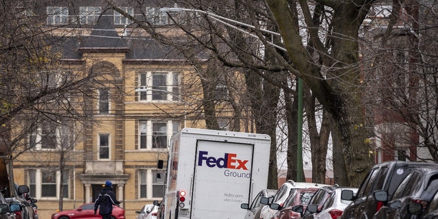 A driver returns to a FedEx Corp. Ground truck in the Lincoln Park neighborhood of Chicago, Illinois, U.S., on Monday, Nov. 30, 2020. 