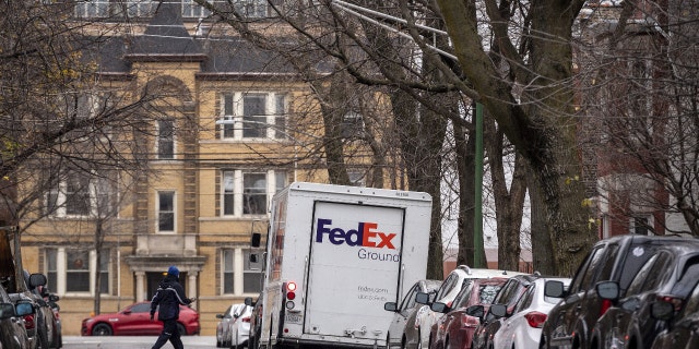 A driver returns to a FedEx Corp. Ground truck in the Lincoln Park neighborhood of Chicago, Illinois, U.S., on Monday, Nov. 30, 2020.