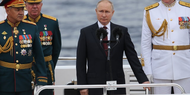 SAINT PETERSBURG, RUSSIA - JULY 25 (RUSSIA OUT): Russian President Vladimir Putin (C) during a military parade to mark Russia's Navy Day on July 25, 2021 in St. Petersburg, Russia. Seen on board a ship. Navy Day military parade held in St. Petersburg despite the coronavirus (COVID-19) pandemic.  (Photo by Mikhail Svetlov/Getty Images)