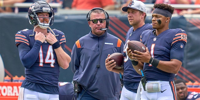 Chicago Bears quarterbacks Justin Fields (1), Nick Foles (9), Andy Dalton (14) and quarterbacks coach John DeFilippo during a preseason game between the Bears and the Buffalo Bills Aug. 21, 2021, at Soldier Field in Chicago. 