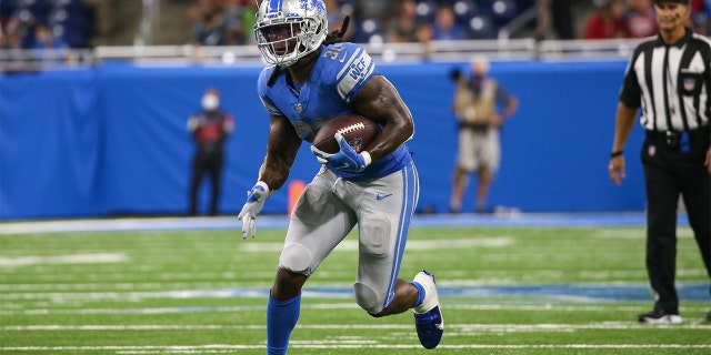 Detroit Lions running back Jamaal Williams (30) runs with the ball during the fourth quarter of a regular season NFL game between the San Francisco 49ers and the Detroit Lions on September 12, 2021 at Ford Field in Detroit, Michigan.
