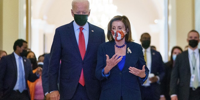 US President Joe Biden walks with Speaker of the House Nancy Pelosi as he departs the US Capitol after a caucus meeting in Washington, DC, on October 1, 2021.