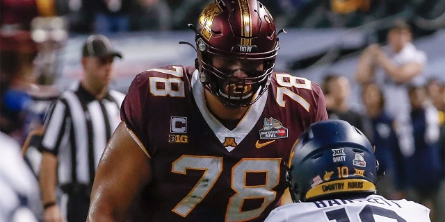 Minnesota Golden Gophers offensive lineman Daniel Faalele (78) looks down on West Virginia Mountaineers linebacker Jared Bartlett (10) during the Guaranteed Rate Bowl between the West Virginia Mountaineers and the Minnesota Golden Gophers Dec. 28, 2021, at Chase Field in Phoenix, Ariz.
