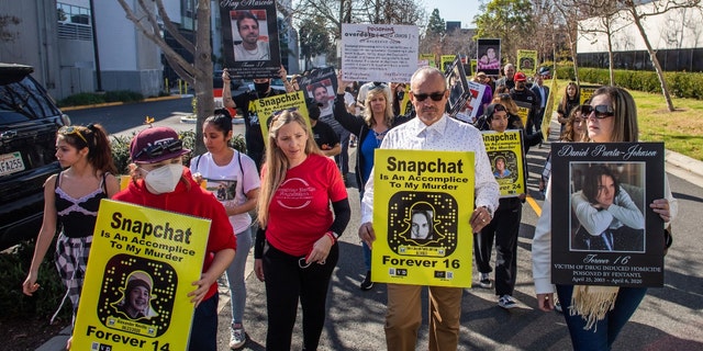 Amy Neville (3rd L) and Jaime Puerta (2nd R) whose children died from fentanyl poisoning protest against illicit drug availability to children on the app Snapchat near the Snap, Inc. headquarters, in Santa Monica, California on January 21, 2022. 