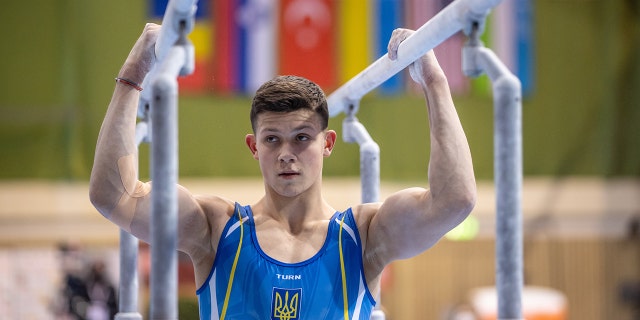 Illia Kovtun from Ukraine prepares for the World Cup men's parallel bars on Feb. 27, 2022.