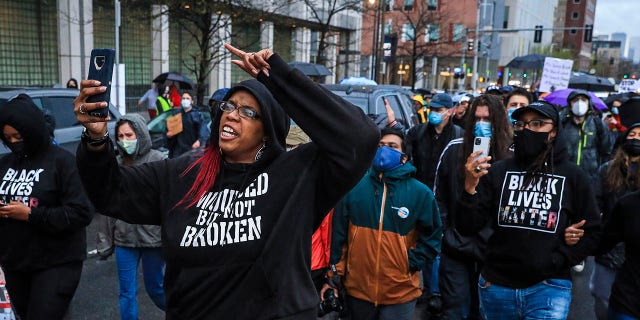 Monica Cannon-Grant leads demonstrators as they march from Nubian Square to BPD headquarters as they celebrate the conviction of former Minneapolis police officer Derek Chauvin in Boston on April 21, 2021. 