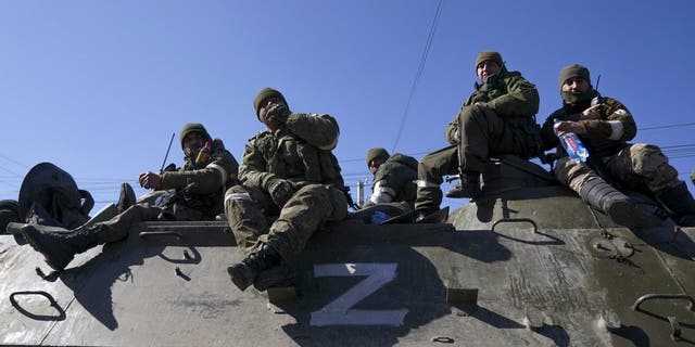 Russian military and pro-Russian separatists keep watch near the Ukrainian city of Mariupol on March 24, 2022. 