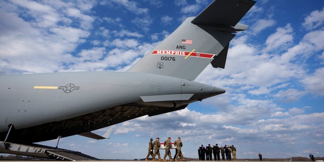 A U.S. Marine Corps carry team carries the transfer case containing the remains of Marine Gunnery Sgt. James W. Speedy of Cambridge, Ohio, during a dignified transfer at Dover Air Force Base March 25, 2022, in Dover, Del.