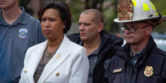 Mayor Muriel Bowser and Metropolitan Police Department Assistant Chief Stuart Emerman approach a press conference after multiple people were injured in a shooting near the Edmund Burke School in Washington, D.C. on April 22, 2022.
