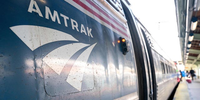 The Amtrak logo is seen on a train at Union Station in Washington, DC on April 22, 2022. (Photo by Stefani Reynolds / AFP)