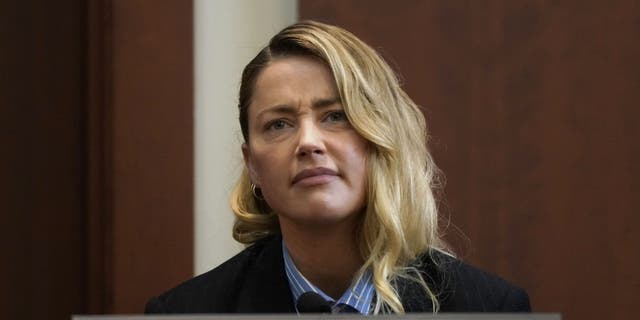 Actor Amber Heard reacts as she testifies at Fairfax County Circuit Court during a defamation case against her by ex-husband, actor Johnny Depp, in Fairfax, Virginia, on May 4, 2022.