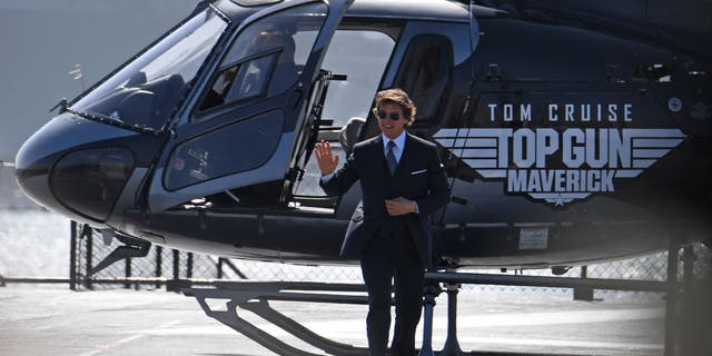 Tom Cruise arrives in a helicopter to the world premiere of "Top Gun: Maverick" aboard the USS Midway in San Diego, California.