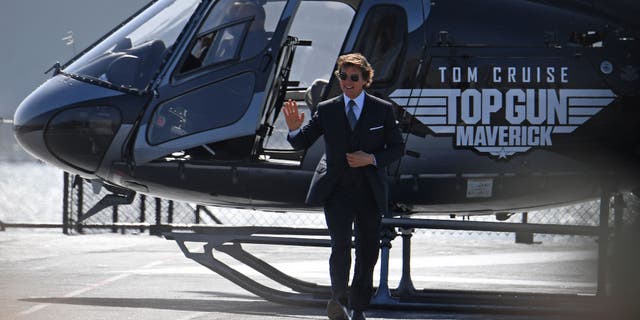 Tom Cruise arrives in a helicopter to the world premiere of "Top Gun: Maverick" aboard the USS Midway in San Diego, California.