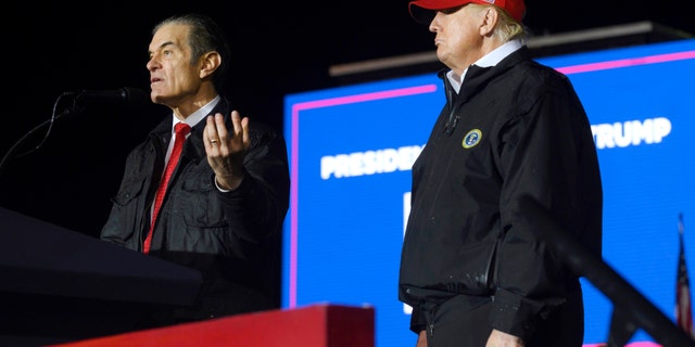 Pennsylvania Republican U.S. Senate candidate Dr. Mehmet Oz joins former President Donald Trump onstage during a rally.