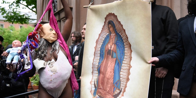 Anti-abortion activists and church members are confronted by a pro-choice activist outside of a Catholic church in downtown Manhattan to voice their support for a woman's right to choose on May 07, 2022 in New York City.