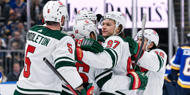 Minnesota players celebrate a goal during the Stanley Cup Playoffs between the Wild and the Blues on April 29, 2022, at the Enterprise Center in St. Louis, Missouri.