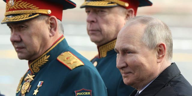 Russian President Vladimir Putin, Defence Minister Sergei Shoigu, left, and Commander-in-chief of Ground Forces Oleg Salukov, center, attend the Victory Day Parade at Red Square on May 9, 2022, in Moscow.