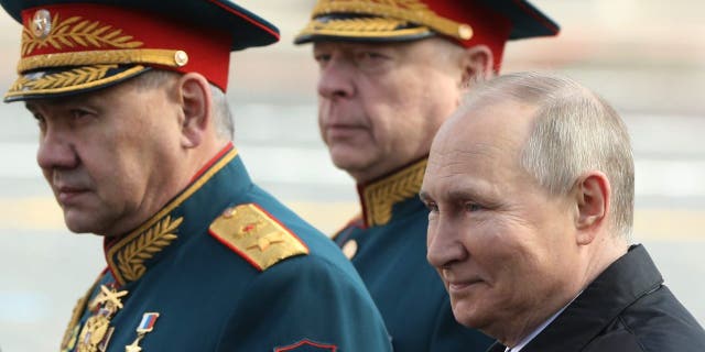 Russian President Vladimir Putin, Defence Minister Sergei Shoigu, left, and Commander-in-chief of Ground Forces Oleg Salukov, center, attend the Victory Day Parade at Red Square on May 9, 2022, in Moscow.