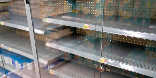 Grocery store shelves where baby formula is typically stocked are locked and nearly empty in Washington, DC, on May 11, 2022. 