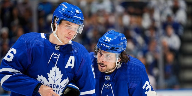 Auston Matthews, right, of the Toronto Maple Leafs talks with teammate Mitch Marner during the first period against the Tampa Bay Lightning in Game 7 of the first round of the 2022 Stanley Cup Playoffs at Scotiabank Arena May 14, 2022, in Toronto. 