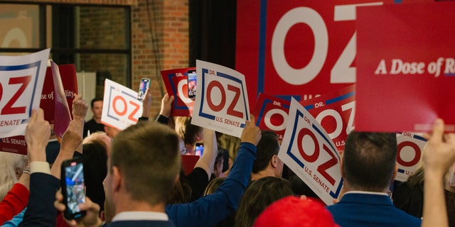 Supporters hold campaign signs for Mehmet Oz, celebrity physician and US Republican Senate candidate for Pennsylvania. Photographer: Michelle Gustafson/Bloomberg via Getty Images