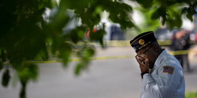 Howard Patton pays his respects at a makeshift memorial across the street from Tops Friendly Market at Jefferson Avenue and Riley Street on Wednesday, May 18, 2022 in Buffalo, NY.