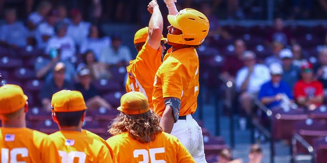 Tennessee Volunteers players celebrate a home run at Dudy Noble Field at the Pork Dement Stadium in Starkville, Mississippi, during a match against the Mississippi State Bulldog. 