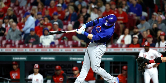 Ian Happ of the Chicago Cubs hits a three-run homer against the Reds at Great American Ball Park on May 23, 2022, in Cincinnati, Ohio.
