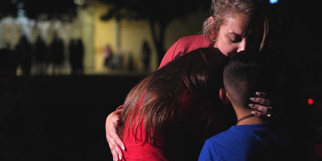 Families hug outside the Willie de Leon Civic Center where grief counseling will be offered in Uvalde, Texas, on May 24, 2022. 