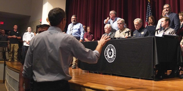 Democratic gubernatorial candidate Beto O'Rourke interrupts Texas Governor Greg Abbott during a press conference to provide updates on the Uvalde elementary school shooting, at Uvalde High School in Uvalde, Texas on May 25, 2022. - The tight-knit Latino community of Uvalde was wracked with grief Wednesday after a teen in body armor marched into the school and killed 19 children and two teachers, in the latest spasm of deadly gun violence in the US. (Photo by allison dinner / AFP) (Photo by ALLISON DINNER/AFP via Getty Images)