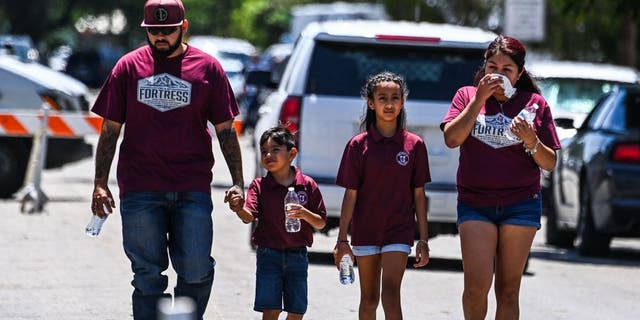 A victim's family walks out of the Robb Elementary School in Uvalde, Texas, on May 25, 2022.