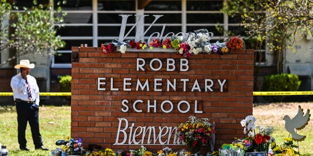 Flowers are placed on a makeshift memorial in front of Robb Elementary School in Uvalde, Texas, on May 25, 2022.