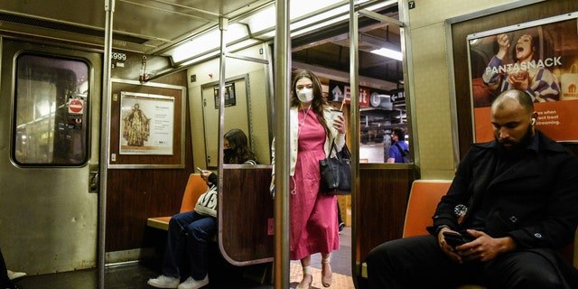 A commuter enters a subway at a station in New York, US, on Wednesday, May 25, 2022. 