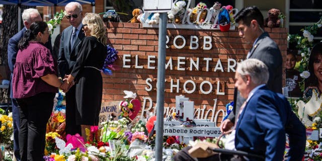 Texas Governor Greg Abbott arrives while President Joe Biden and First Lady Jill Biden greet Mandy Gutierrez, principal of Robb Elementary School, and Superintendent Hal Harrell in Uvalde, Texas on May 29, 2022.