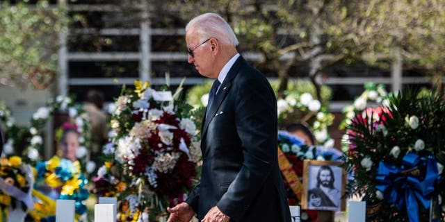 US President Joe Biden pays respect at a makeshift memorial outside of Robb Elementary School in Uvalde, Texas on May 29, 2022.