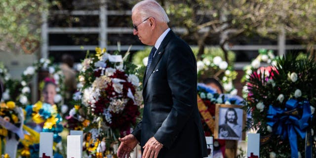 US President Joe Biden pays respect at a makeshift memorial outside of Robb Elementary School in Uvalde, Texas on May 29, 2022.