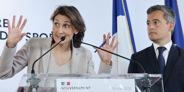 French Sports, Olympic and Paralympic Games Minister Amelie Oudea-Castera (L) gestures next to French Interior Minister Gerald Darmanin (R) during a press conference after a meeting at French sports ministry in Paris to identify those responsible for unrest during the UEFA Champions League football final, on May 30, 2022.