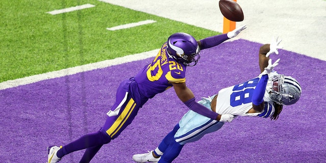 CeeDee Lamb #88 of the Dallas Cowboys pulls in a touchdown pass against Jeff Gladney #20 of the Minnesota Vikings during their game at U.S. Bank Stadium on November 22, 2020, in Minneapolis, Minnesota. 