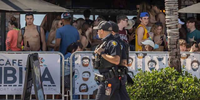 Fort Lauderdale Police officers walk past Café Ibiza March 4, 2021, in Fort Lauderdale, Fla.