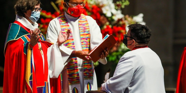 SAN FRANCISCO, CA - SEPT. 11: Elizabeth Eaton, presiding bishop of the Evangelical Lutheran Church in America, left, delivers words to Rev. Dr. Megan Rohrer, right, (they/them) as they become the first openly transgender bishop of the Evangelical Lutheran Church in America after they were installed to the Sierra Pacific Synod at Grace Cathedral on Saturday, September 11, 2021, in San Francisco, Calif. (Yalonda M. James/The San Francisco Chronicle via Getty Images)