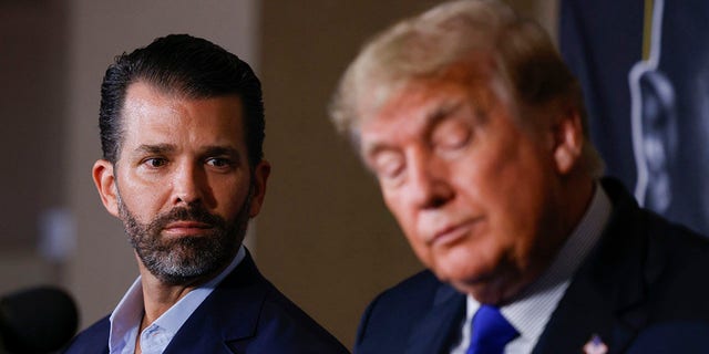 Donald Trump Jr. and former President of the United States Donald Trump look on prior to the fight between Evander Holyfield and Vitor Belfort during Evander Holyfield vs. Vitor Belfort presented by Triller at Seminole Hard Rock Hotel &amp; Casino on September 11, 2021 in Hollywood, Florida. 